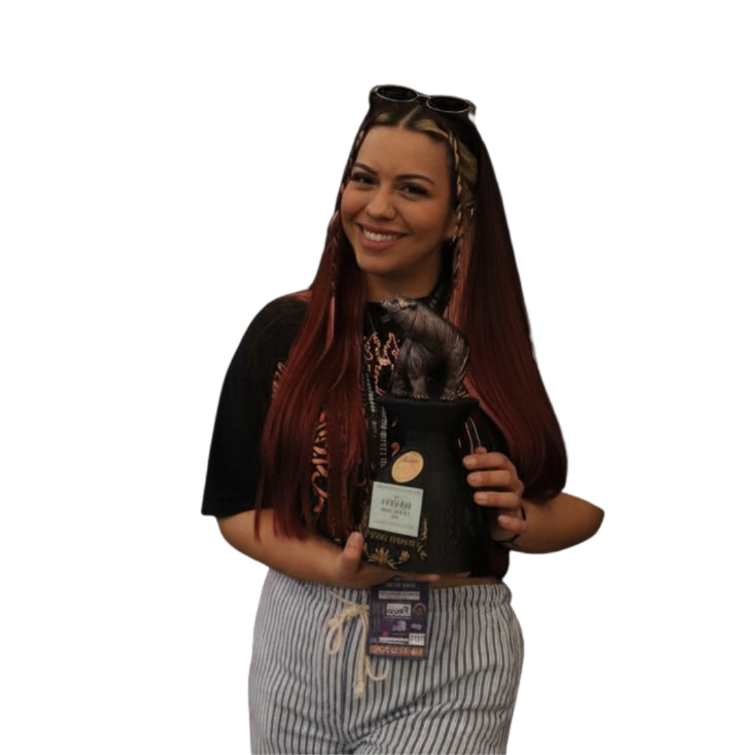 Keila Soto holding a tattoo award, smiling